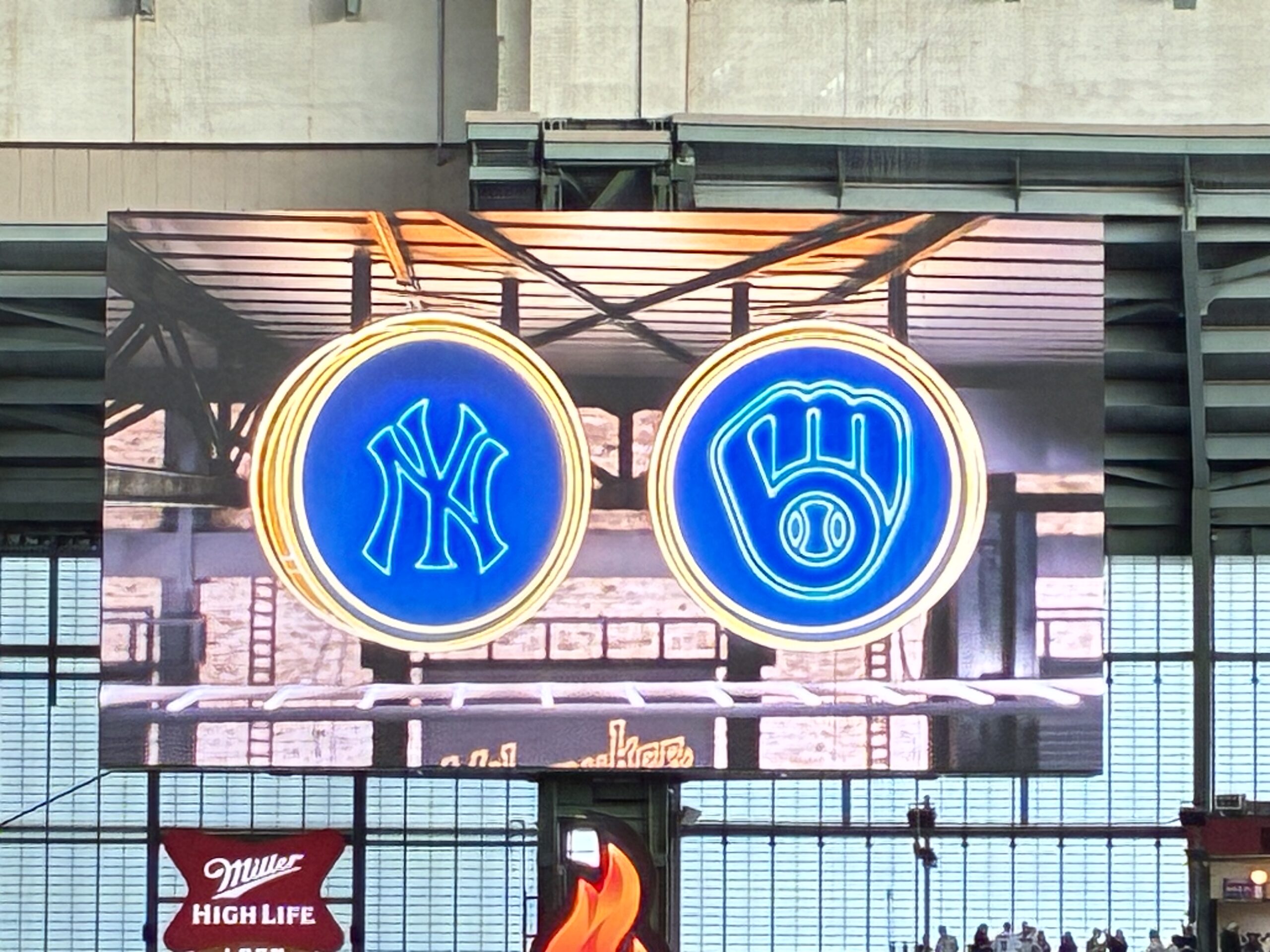 Yankees and Brewers logos on the main scoreboard